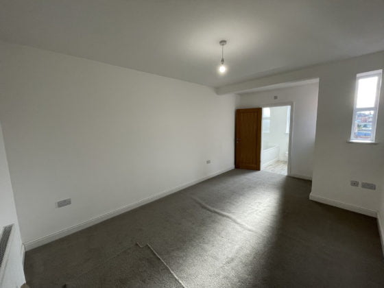 Empty room with grey carpet and white walls