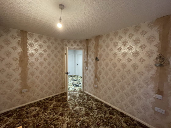 Empty room during renovation, vintage wallpaper.