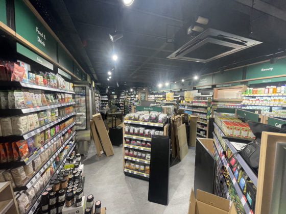 Well-stocked health food store interior with aisles.