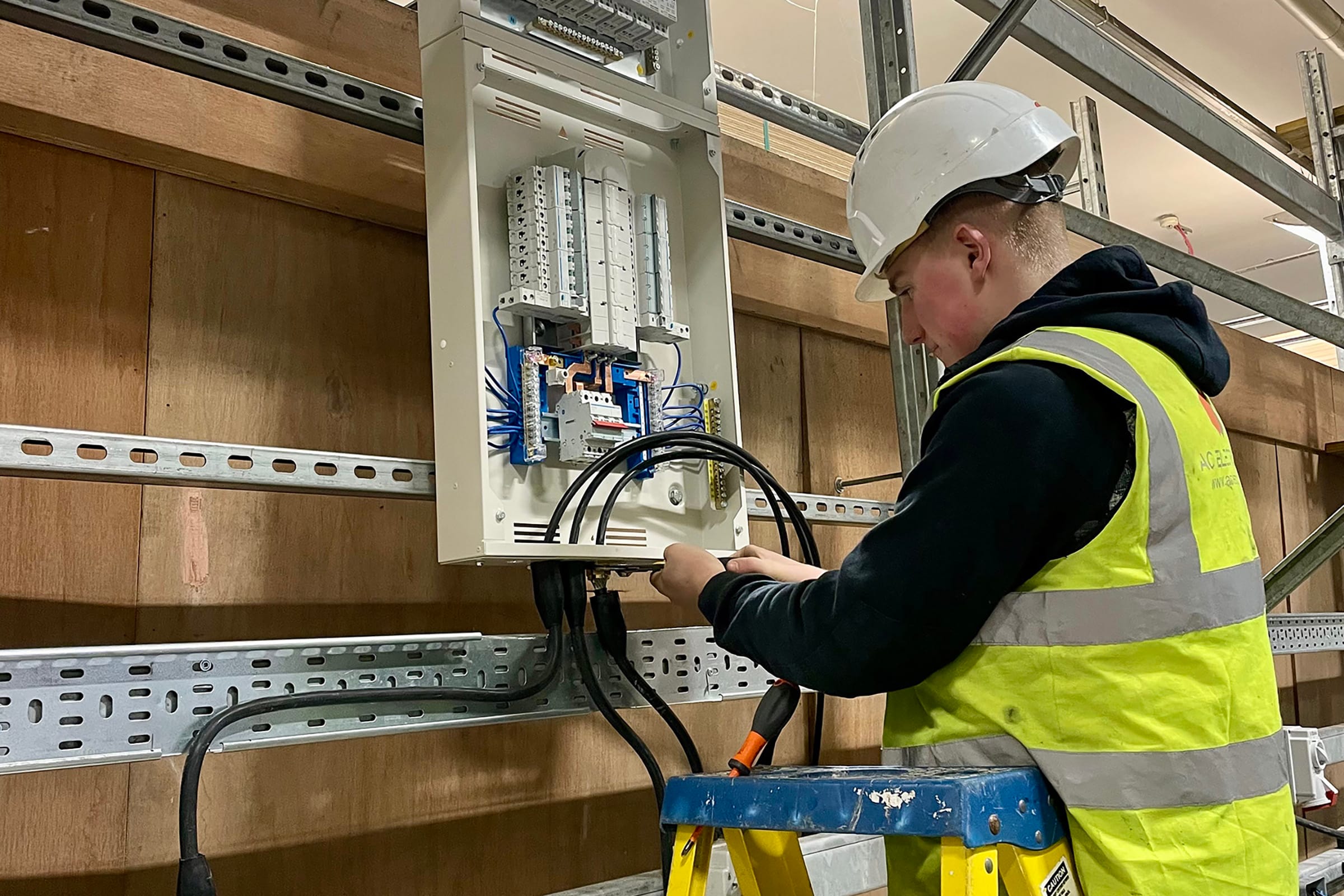 Electrician working on fuse box installation