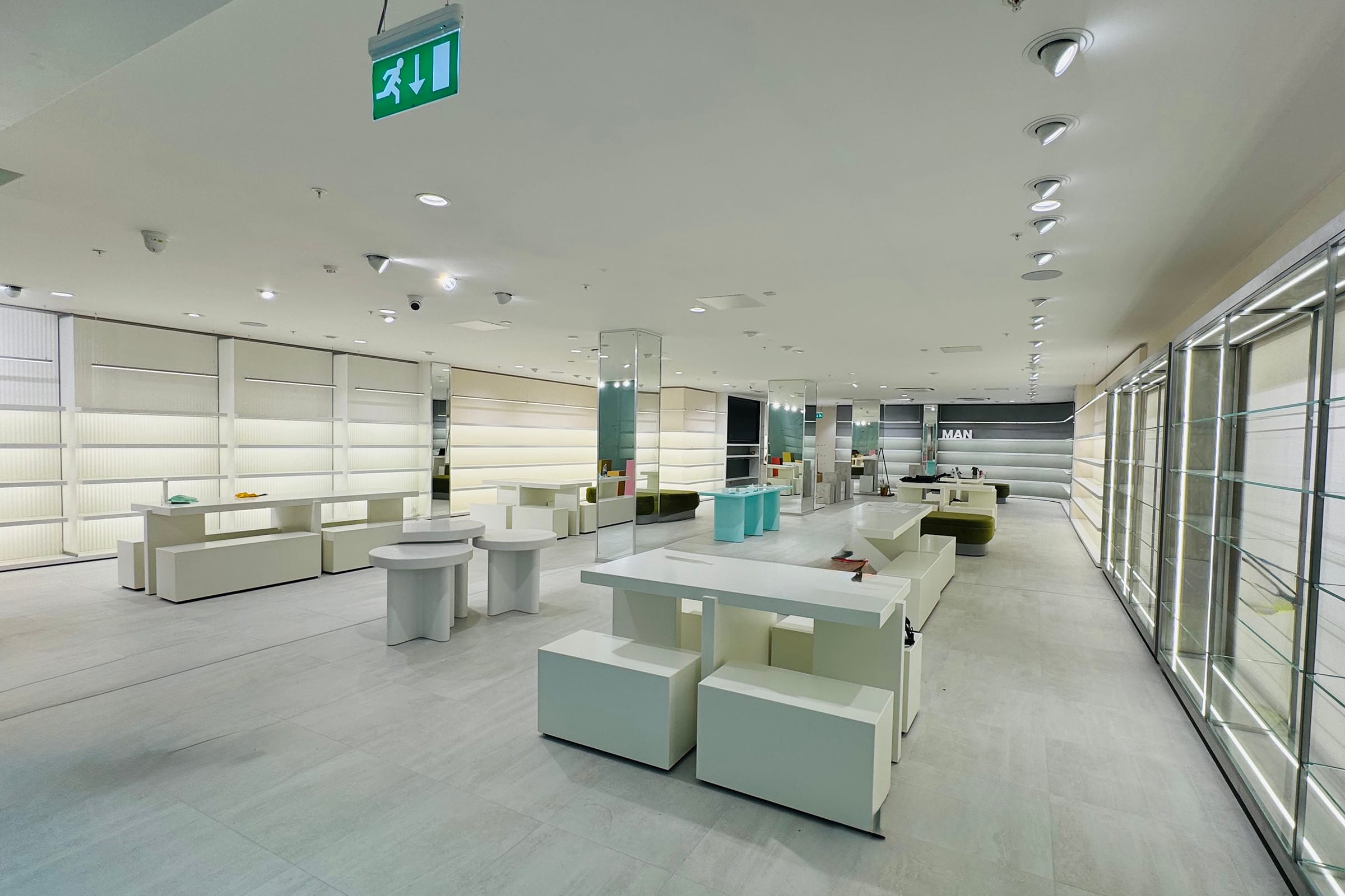 Modern retail store interior with white furniture.
