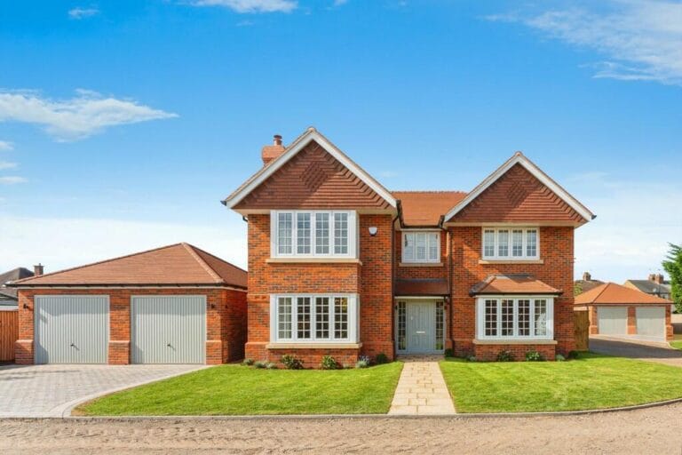 Modern red brick house with twin garages.